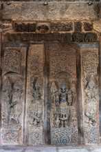 Belur, Karnataka, India - November 2, 2013: Chennakeshava Temple. Brown Wall Stone Panel Sculpture Of Lord Vishnu Surrounded By His Two Consorts Devi Lakshmi And Devi Bhu With Shilabalika Women. On Si