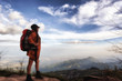 © Sirirat Makprasert - Asian young woman backpacker enjoy and stretching with sky background in nature, her is feeling relax and happy in the mountain; Travel and backpack concept.