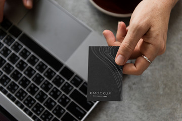 female hand holding a business card mockup