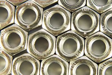 Pile of metal screw-nuts on a white background