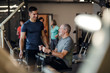 © Halfpoint - A senior man with a young trainer doing strength workout exercise in gym.