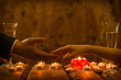 © Konstiantyn Zap - A man and a woman at a romantic dinner. The hand of a man and a woman reach for each other by candlelight.