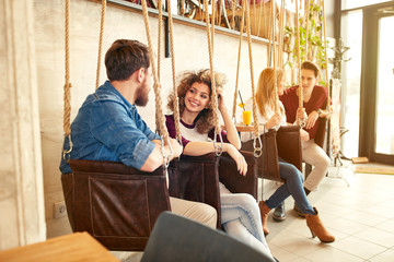 Wall Mural - Men and women talking on swing