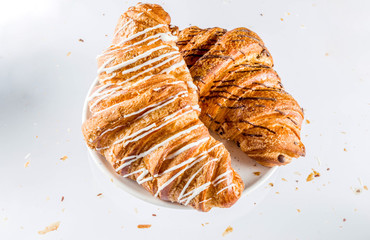 Freshly baked croissant on white background, top view copy space