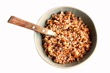 Bowl with buckwheat. Closeup. Isolated on white. Top view.