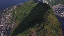 Favela Aerials: High Shot Rising Above Mountain With Favelas Either Side In Rio De Janeiro, Brazil