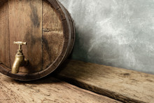 Wooden Barrel With Tap And Worn Old Table Of Wood.
