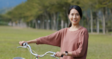 Wall Mural - Woman ride a bike in countryside