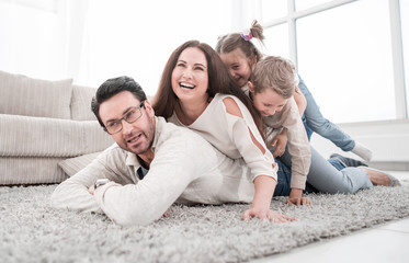 Wall Mural - Happy family at home spending time togethe