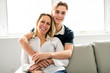 © Louis-Paul Photo - A people and family happy teen boy with mother on sofa at home