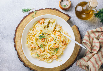 Wall Mural - Italian pasta tagliatelle in a creamy sauce with shrimp