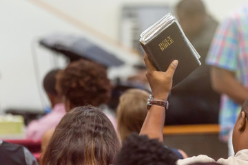 Wall Mural - African American Man at Church with a Bible Raised