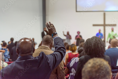 Fotografía African American Man at Church with His Hand Raised