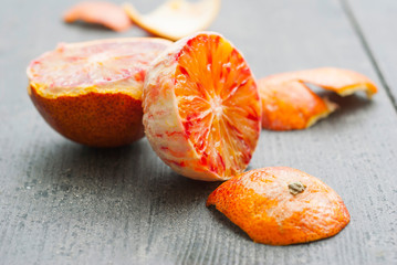 Wall Mural - peeled blood oranges on dark wood table