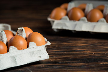 Wall Mural - chicken eggs on old wooden board with blank space for text