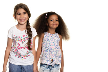 Wall Mural - Hispanic and african american small girls  on a white background