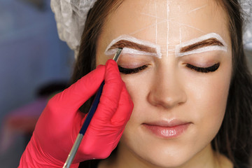 Eyebrow correction. Eyebrow dyeing and hair drawing to create perfect shape. Work of master cosmetologist.