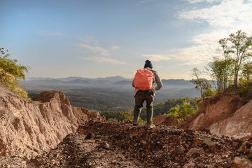 Tourist on the peak of high rocks. Sport and active life concept