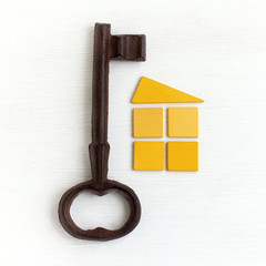 non-standard solutions for life. large metal key and a symbol of the house