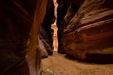 Wall Mural - The beautiful Al Khazneh (The Treasury) seen through a canyon's walls in Petra. Petra is a historical and archaeological city in southern Jordan.