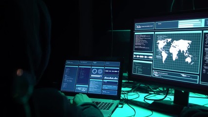 Wanted hackers coding virus ransomware using laptops and computers in the basement. Cyber attack, system breaking and malware.