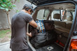 © Odua Images - portrait of young asian man travel by car alone