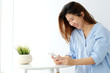 © mangpor2004 - Young asian woman using smart phone with smiling, happy and relax emotion in white room background, people on phone, lifestyle