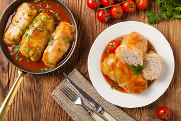 Wall Mural - Traditional stuffed cabbage with minced meat and rice, served in a tomato sauce.