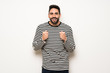 © luismolinero - handsome man with striped shirt celebrating a victory in winner position