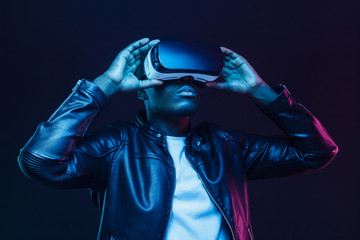 African american man in vr glasses, watching 360 degree video with virtual reality headset isolated on black background
