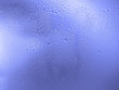 © Olesya - Drops of water on the glass, blue color. Image for background or wallpaper.