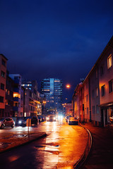 Wall Mural - Moody night street city view with cars and skyline buildings and dark winter sky. Köln, Cologne in Germany