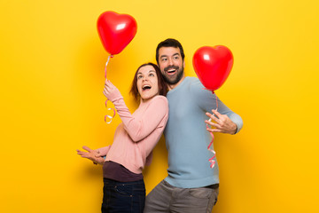 Couple in valentine day with balloons with heart shape