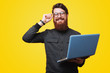 © Vulp - Portrait of happy smart bearded guy, holding a laptopand touchig his glasses