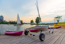 Sailing In Boston On The Charles River. Cart For Sailboats On The Wooden Dock. Copy Space For Your Text