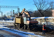 © MaxSafaniuk - The excavator loads crushed stone in a dump truck body. Construction of the railway. Preparing the surface of the earth for laying railways. Worker controls work at the construction site