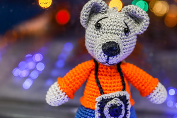 Knitted bear with a camera