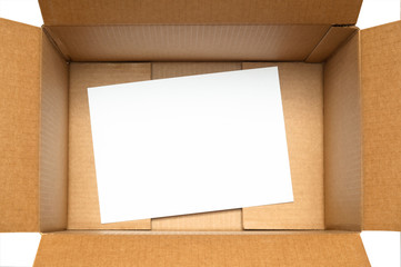 cardboard box with white sheet of paper on white background