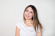 © Hazal - Portrait of young beautiful cute cheerful girl smiling looking at camera over white background.
