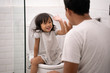 oddler high five with her dad while toilet traning