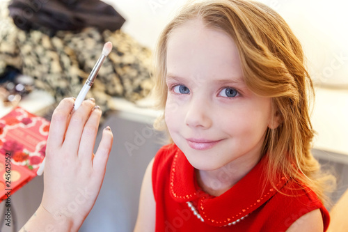 Hand Of Makeup Master Applying Mascara For Little Pretty Girl