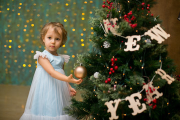 Wall Mural - little girl under the christmas tree with christmas gifts