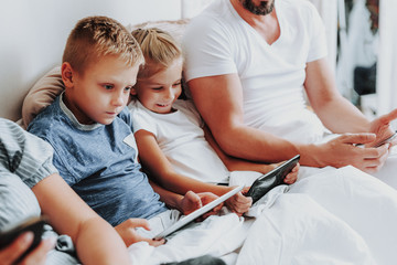 Wall Mural - Close up two kids spending morning with tablets