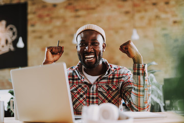 Happy freelancer celebrating his success and smiling