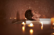 © Yakobchuk Olena - Young lady enjoy relaxed spa bath with candle