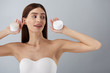 © Yakobchuk Olena - Joyful pretty lady in white bra demonstrating cosmetic products
