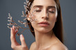 © Yakobchuk Olena - Attractive girl holding beautiful sprigs with tiny white flowers near her face