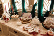 © nagaets - Candy bar. White wedding cake standing of festive table with deserts, tartlet and cupcakes. Wedding.