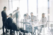 © alfa27 - Side view of blurred silhouettes of businessmen talking in conference room, view through the transparent glass wall
