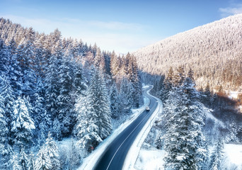 Wall Mural - aerial view on the road and forest at the winter time. natural winter landscape from air. forest und